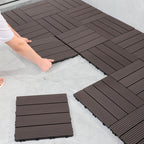 Brown interlocking foam tiles being installed on a floor.