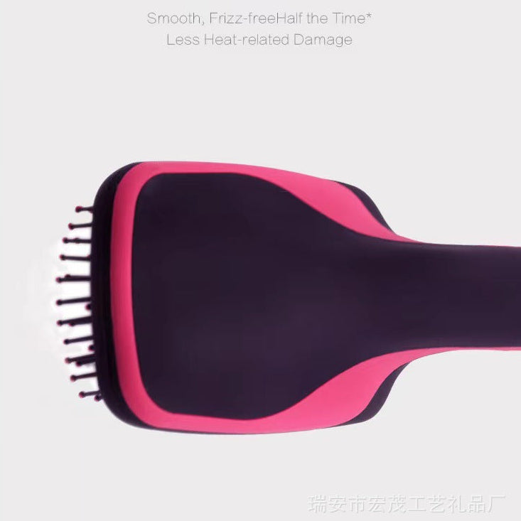 A pink and black hairbrush is shown on a light gray background with English promotional text above it. The brush has a dark purple-black head with pink trim and black bristles.