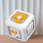 Toy cube with orange and white design on a neutral background