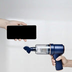 Handheld vacuum cleaner being held next to a smartphone with text comparing weight.