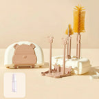 Baby bottle cleaning set with various brushes and a storage case on a beige background