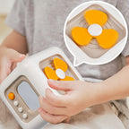 Children's educational toy with orange and white design, held by a child's hands.