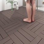Wooden flooring tiles with a person standing on them, near a glass of water and bottles.