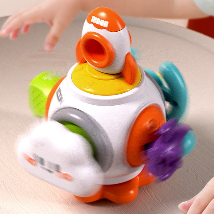 Colorful toy with a child's hand interacting with it on a wooden surface